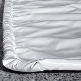Close-up of raised foam edge barrier on Floor Defender garage floor mats showing waterproof seam design